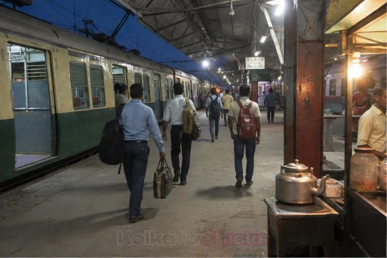 Office commuters on a suburban station platform like Khardah in the evening
